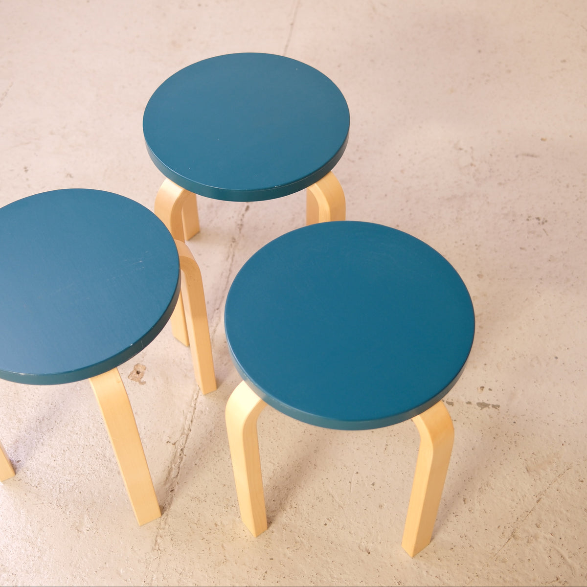 Alvar Aalto Stool E60 with Blue-Green Seat for Artek, artek E60 stools viewed from above, showing blue-green painted seats