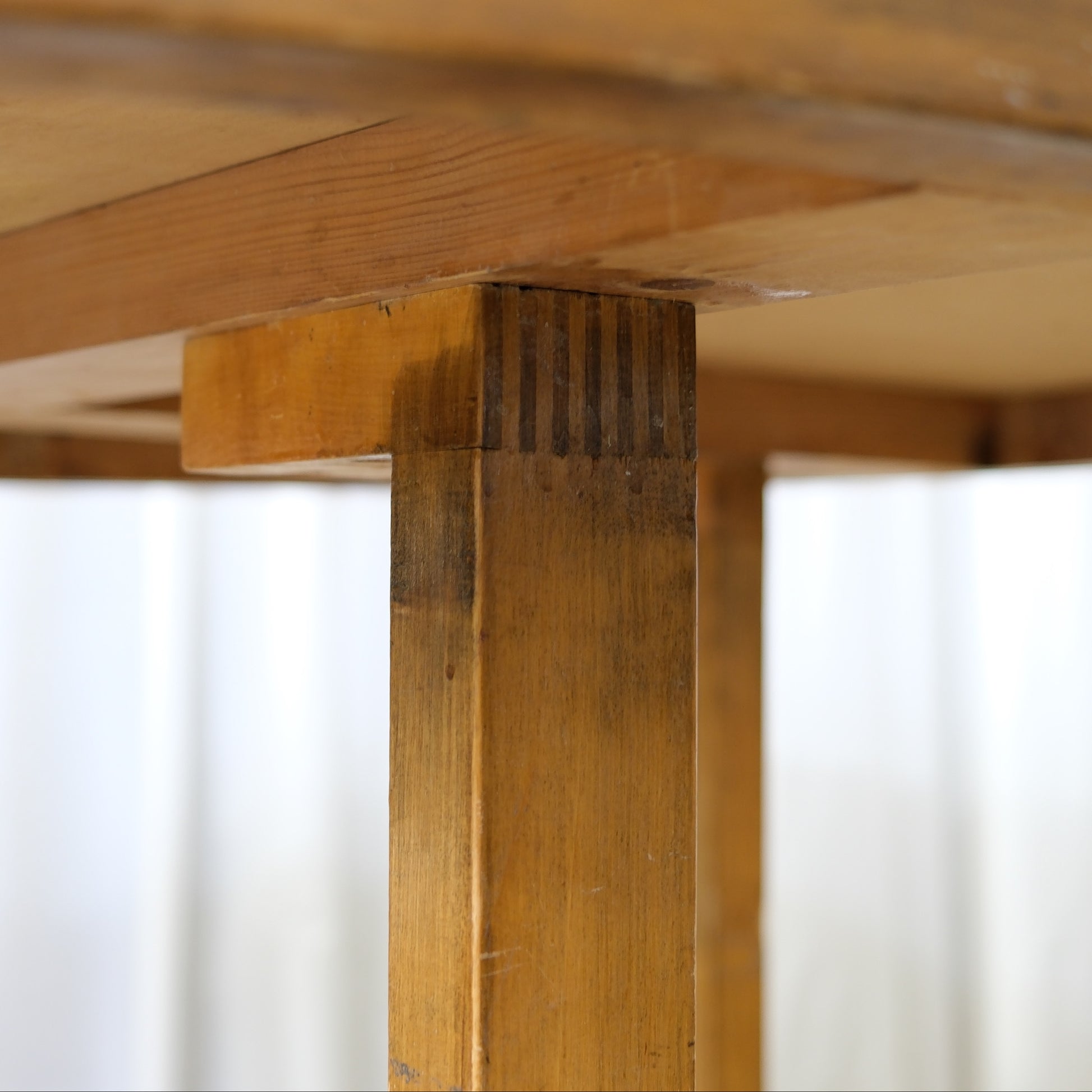 Close view of the table leg joint and underside construction