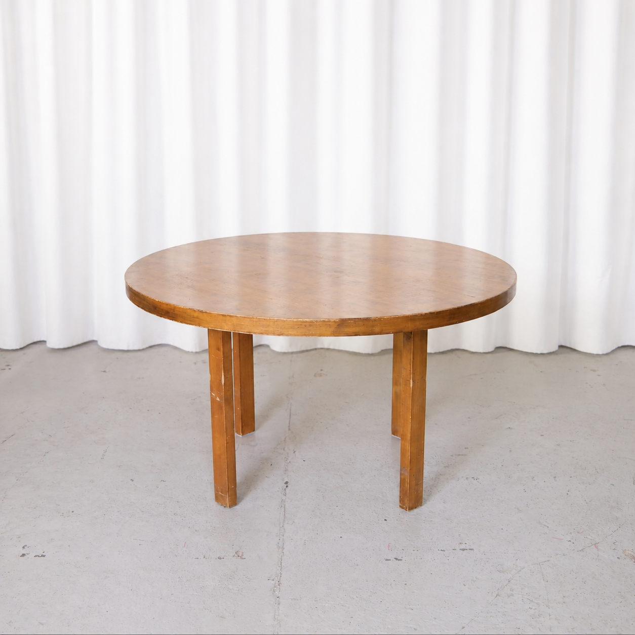 Round birch dining table by Alvar Aalto, straight-on view