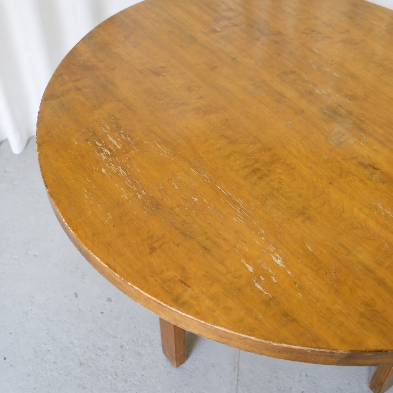 Patina and wear visible across the round birch tabletop