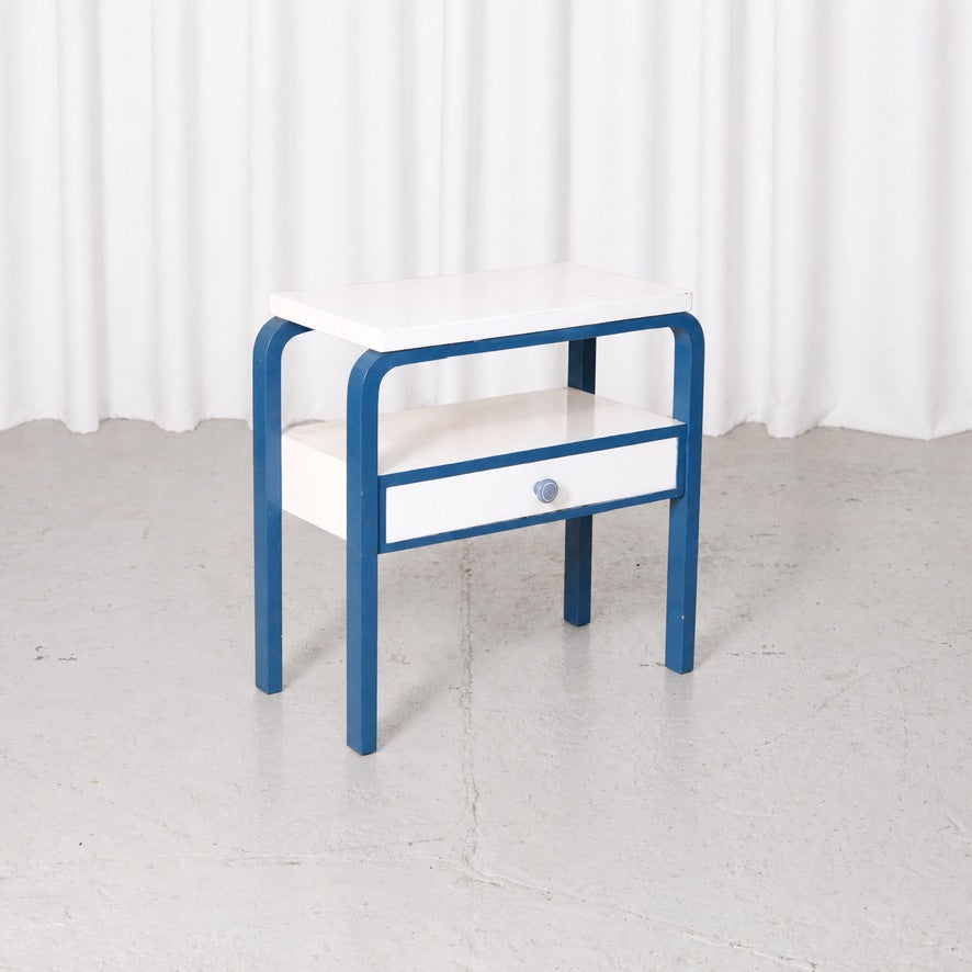 Blue and white Artek side table viewed from the front