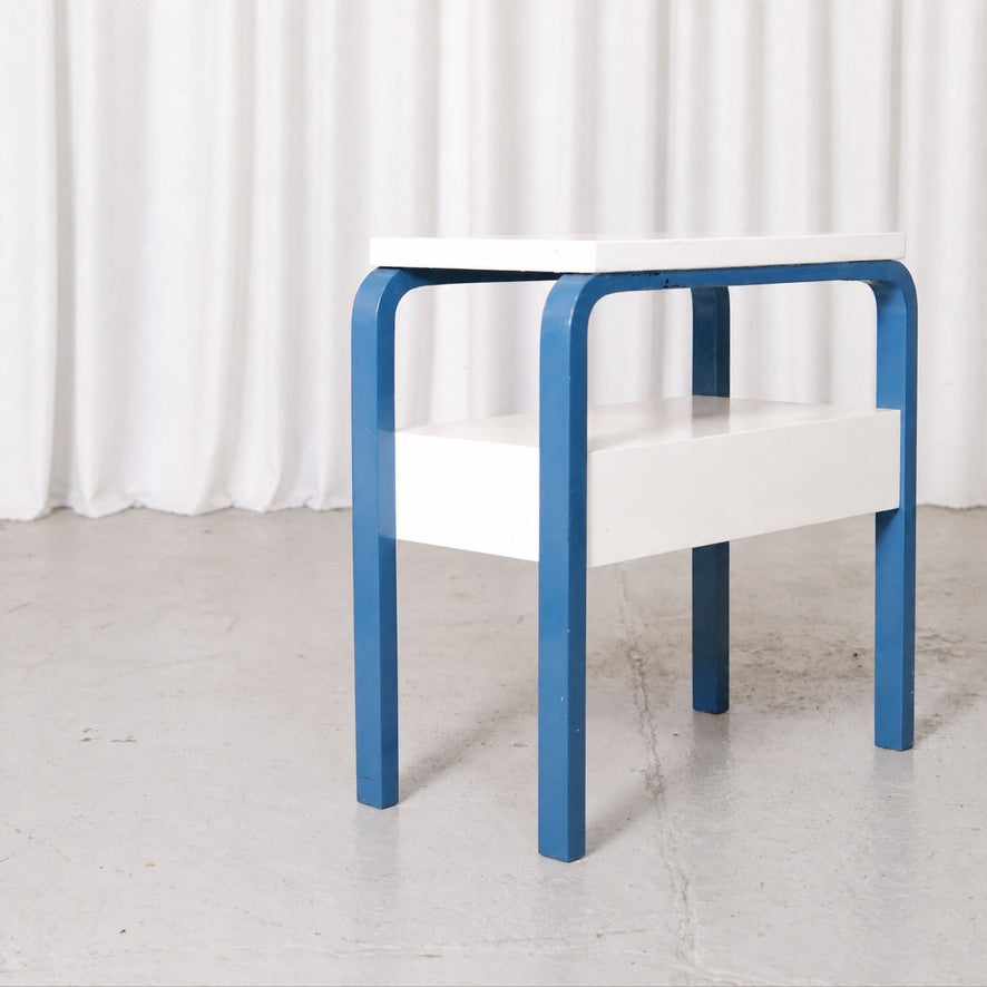 Blue and white Artek side table viewed from the side