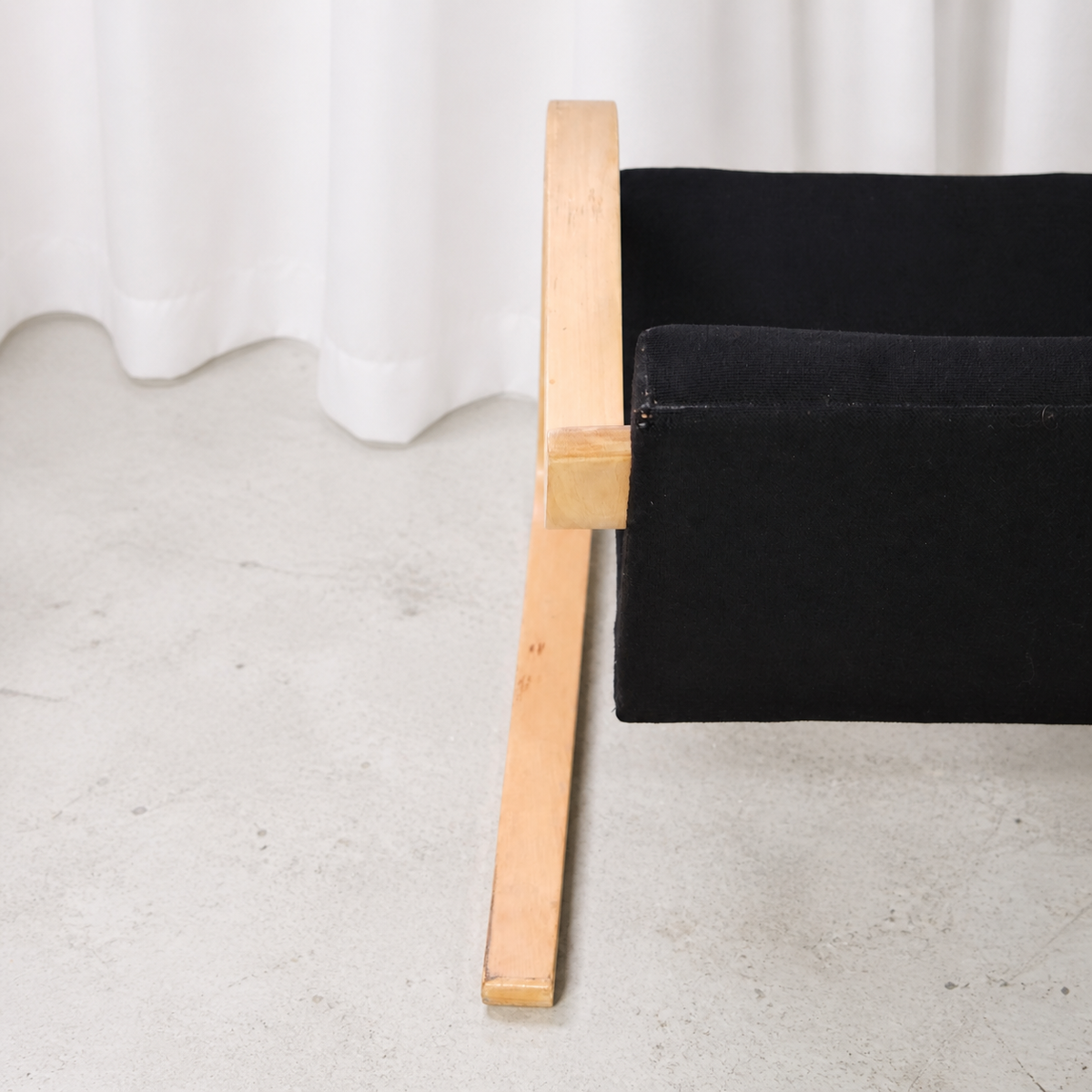 Detail of the slightly splayed birch runner on an Artek 402 armchair