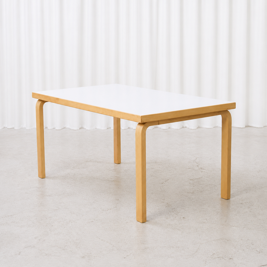 Artek 82A table with white laminate top and birch frame, three-quarter view