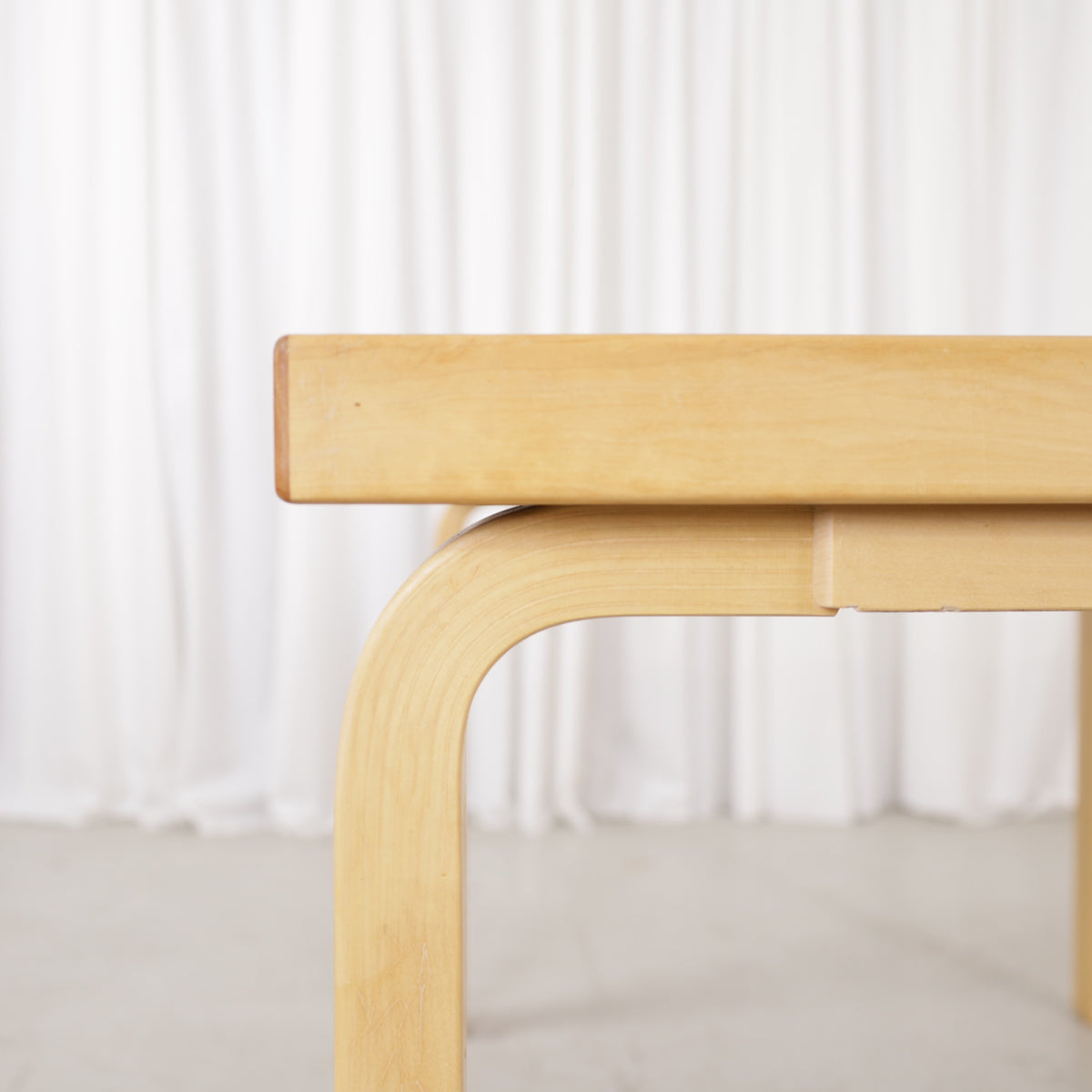 Alvar Aalto 82A table for Artek with white top and birch legs — tabletop edge and birch frame detail
