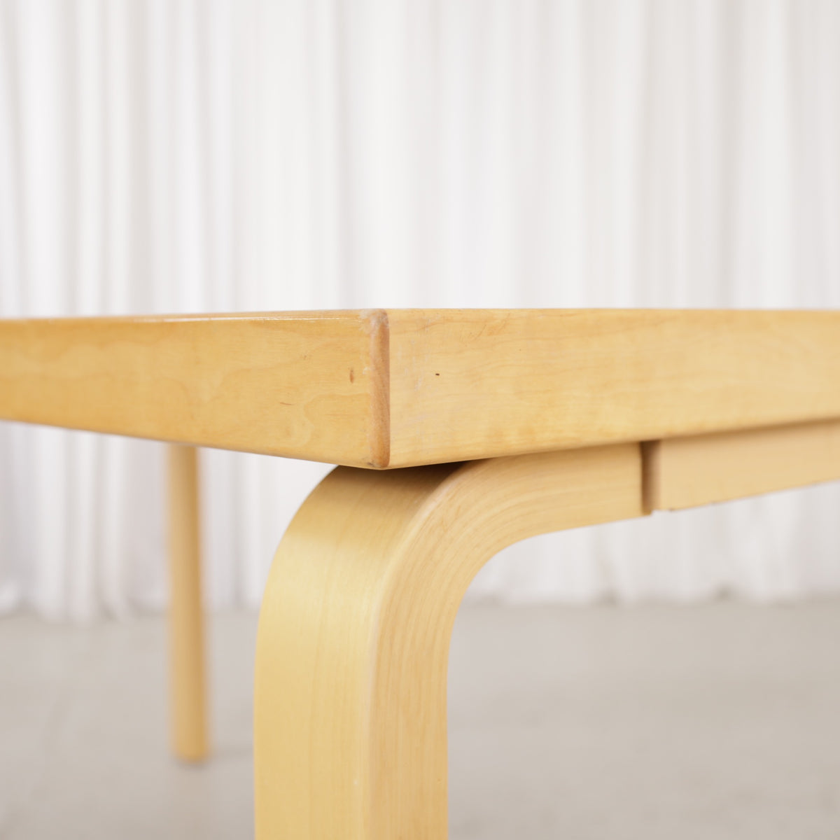 Alvar Aalto 82A table for Artek with white top and birch legs — tabletop edge and birch frame detail