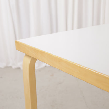 Alvar Aalto 82A table for Artek with white top and birch legs — tabletop edge and birch frame detail