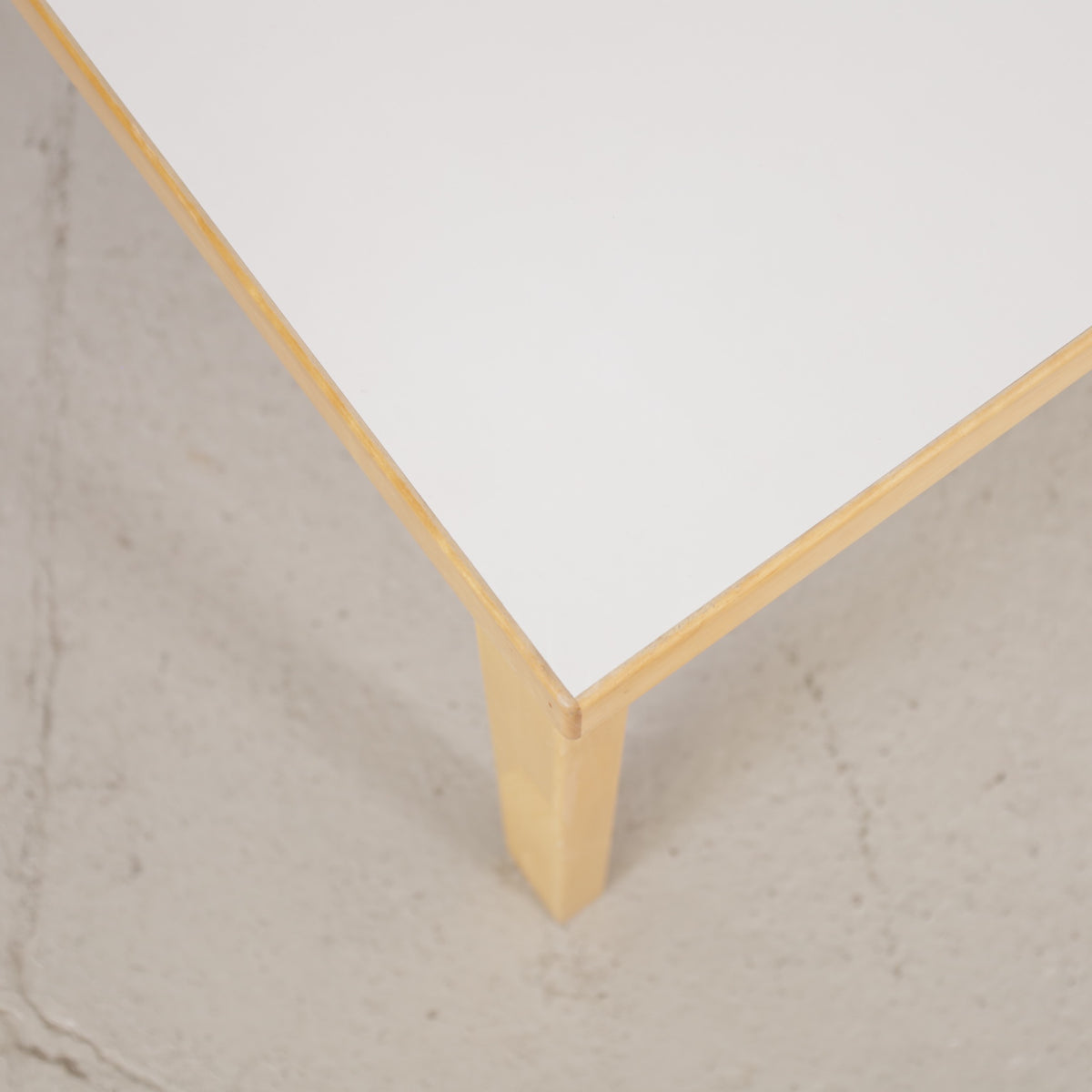 Alvar Aalto 82A table for Artek with white top and birch legs — tabletop edge and birch frame detail