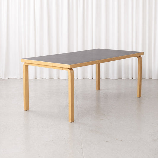 Artek Table 83 in birch with black linoleum top, three-quarter view