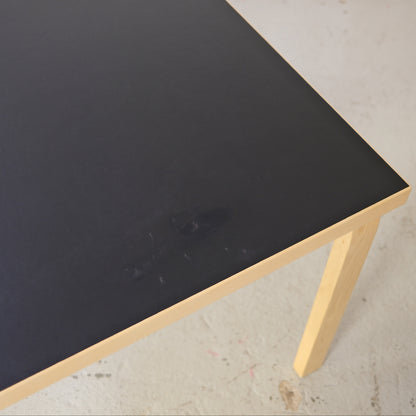 Small residue mark visible on the black linoleum top of Artek Table 83