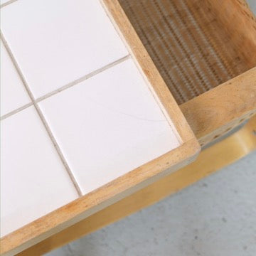 Detail of tile surface and worn birch edge