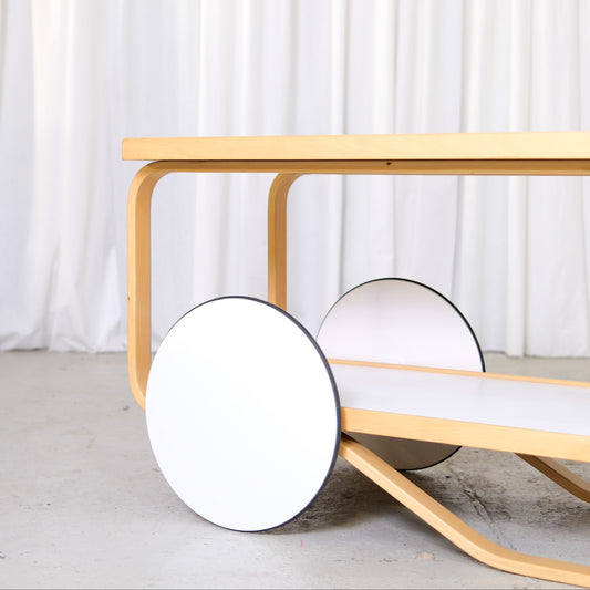 Artek 901 Tea Trolley in White Laminate by Alvar Aalto, artek 901 tea trolley by Alvar Aalto with white laminate shelves, wheel and lower shelf detail