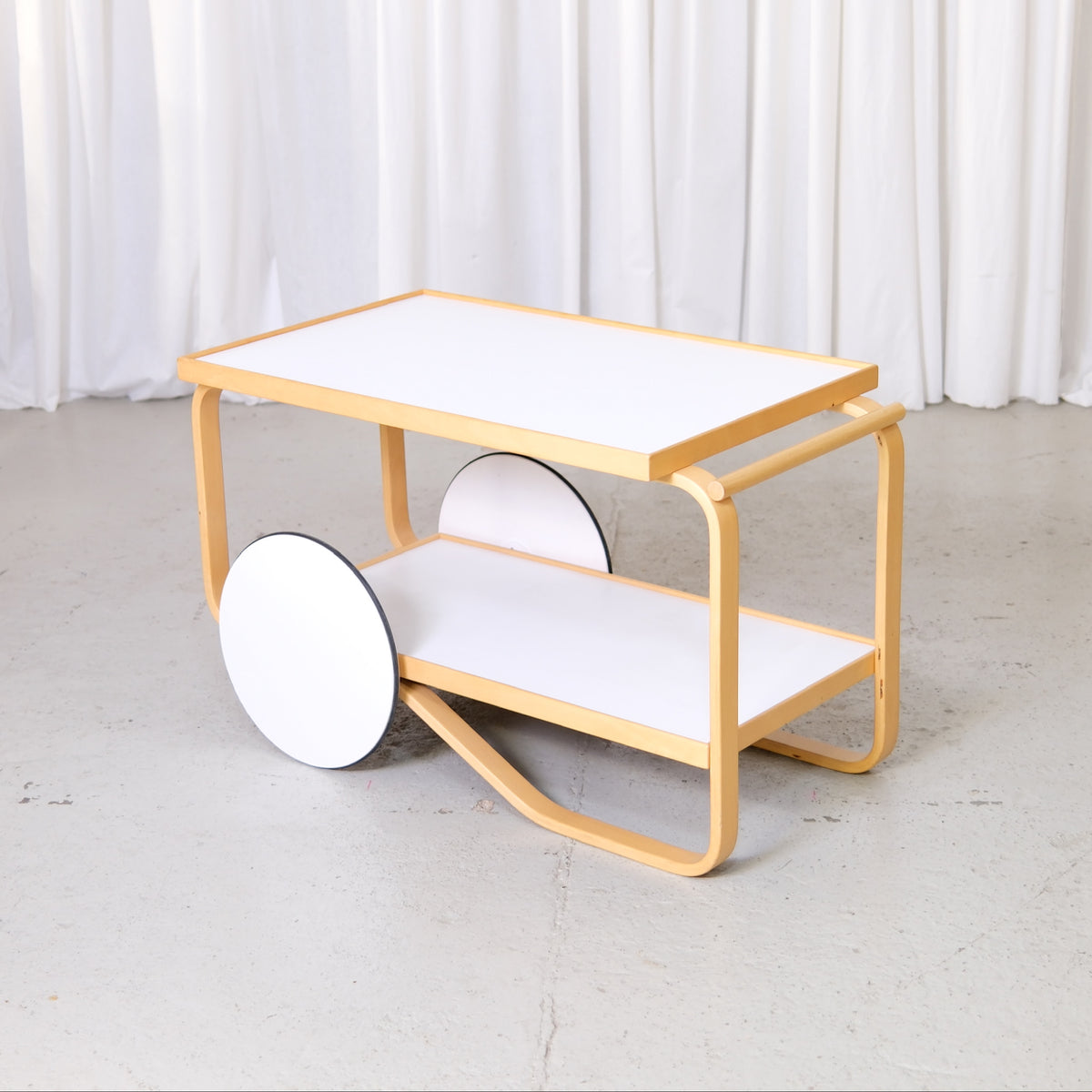 Artek 901 Tea Trolley in White Laminate by Alvar Aalto, artek 901 tea trolley by Alvar Aalto with white laminate shelves, three-quarter view