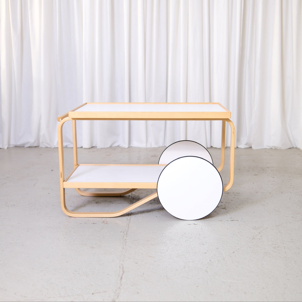 Artek 901 Tea Trolley in White Laminate by Alvar Aalto, artek 901 tea trolley by Alvar Aalto with white laminate shelves, front view