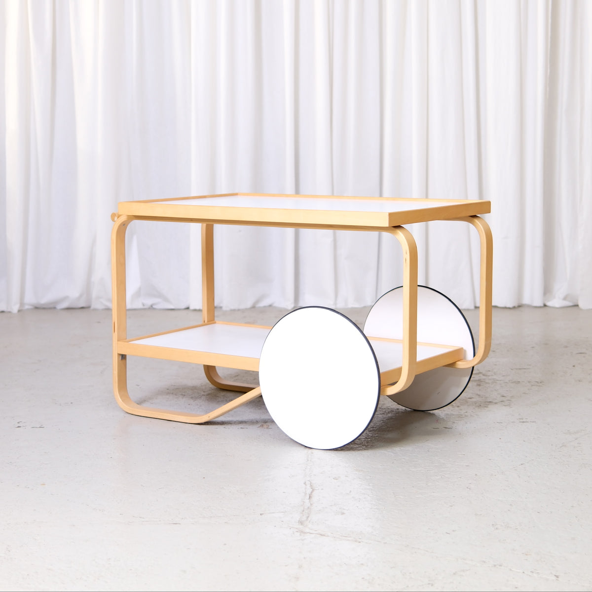 Artek 901 Tea Trolley in White Laminate by Alvar Aalto, artek 901 tea trolley by Alvar Aalto with white laminate shelves, opposite three-quarter view