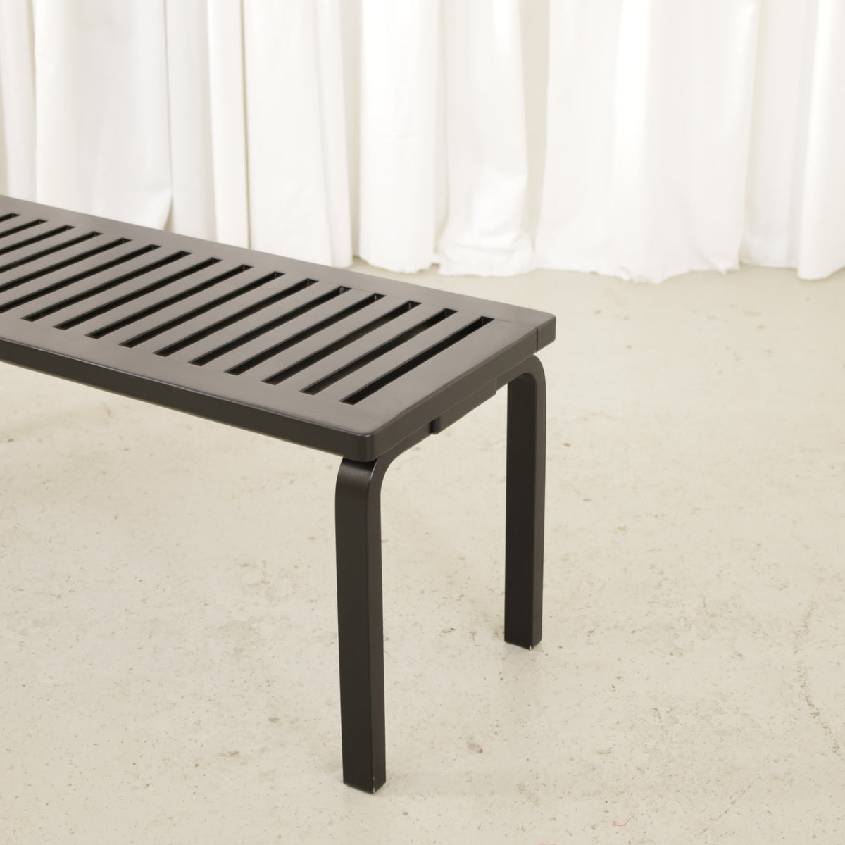 Artek Bench 153A by Alvar Aalto, black, slatted seat and bent leg of black Artek Bench 153A