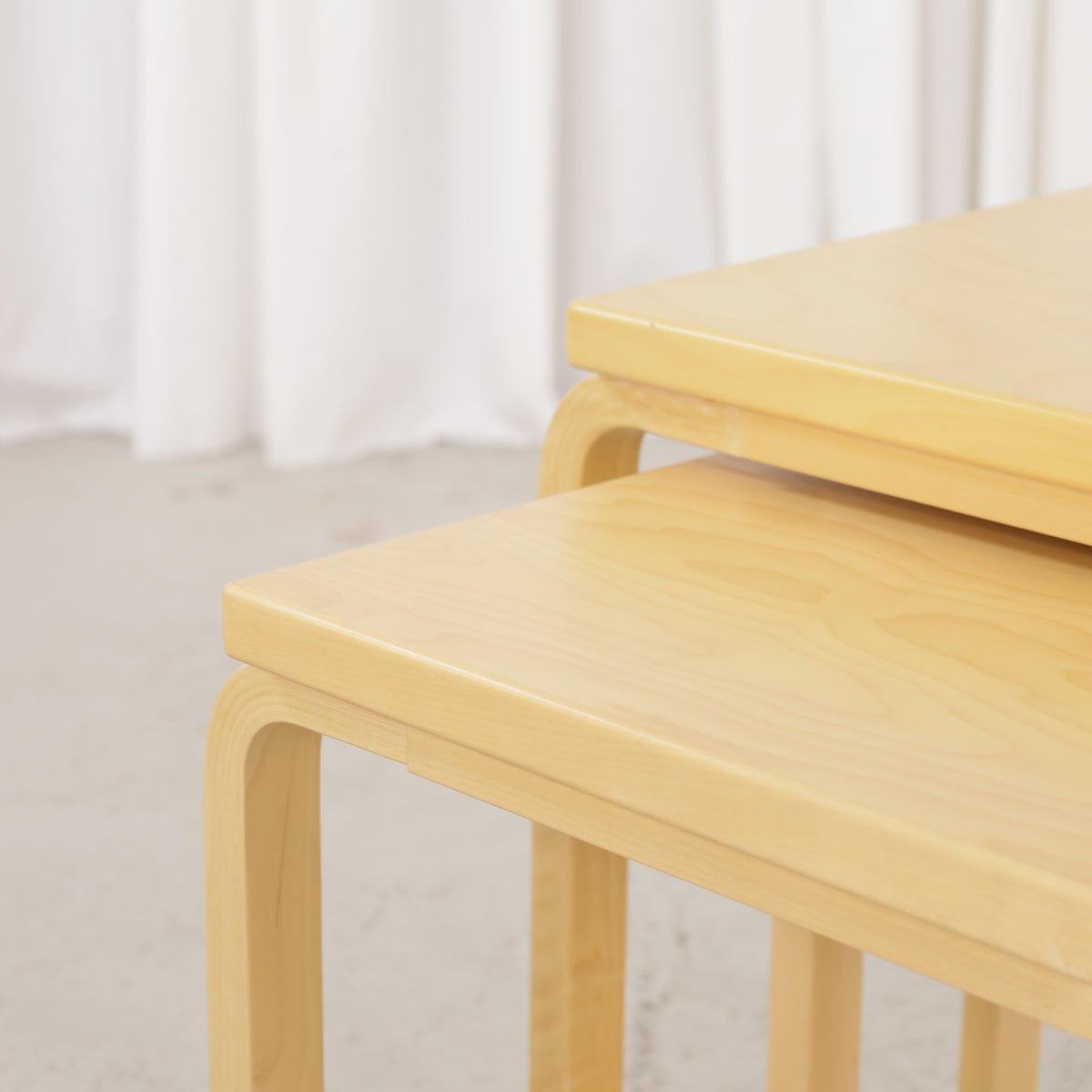 Alvar Aalto birch nesting tables for Artek — tabletop and bent leg detail