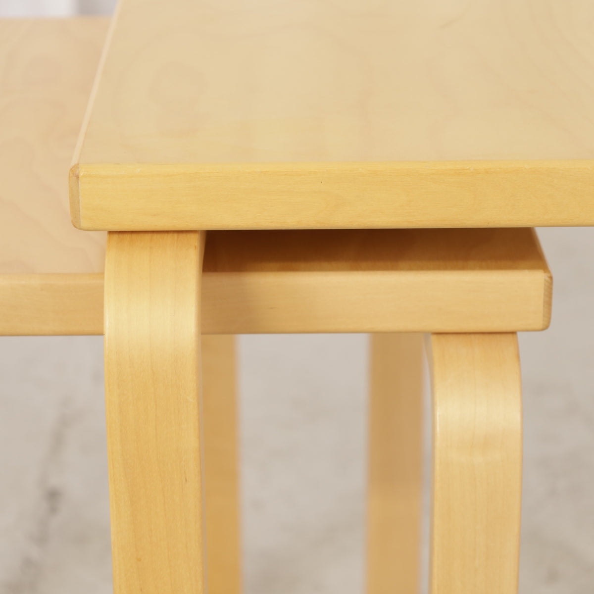 Alvar Aalto birch nesting tables for Artek — tabletop and bent leg detail