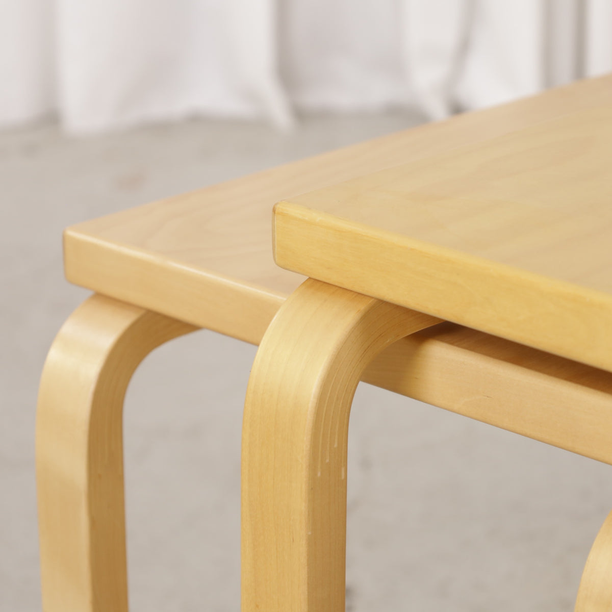 Alvar Aalto birch nesting tables for Artek — tabletop and bent leg detail