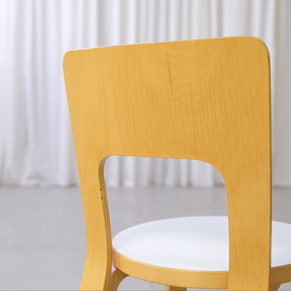Close-up of the curved birch backrest and white laminate seat
