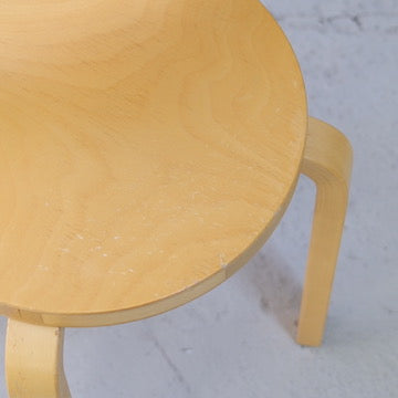 Close-up of light surface wear on the birch seat of an Artek Chair 66