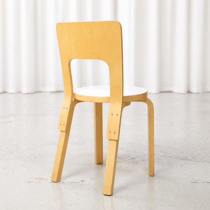 Rear view of Artek Chair 66 in birch with a white laminate seat