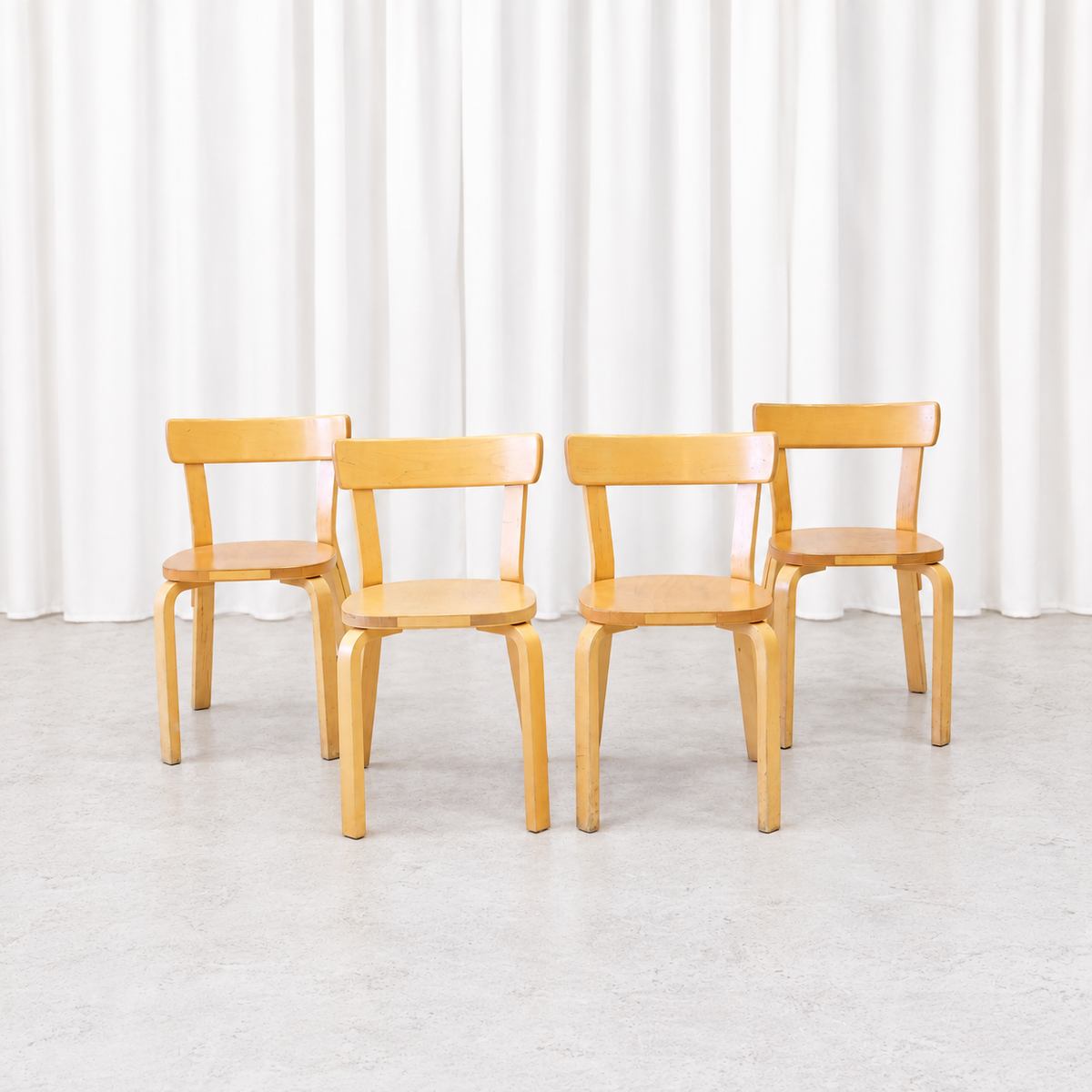 Four vintage Artek Chair 69 chairs in natural birch shown from the front