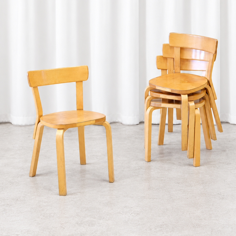 Four vintage Artek Chair 69 chairs in birch, with one chair beside a stacked group