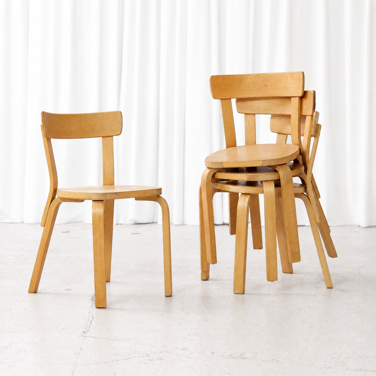 Four vintage Artek Chair 69 chairs shown individually and stacked