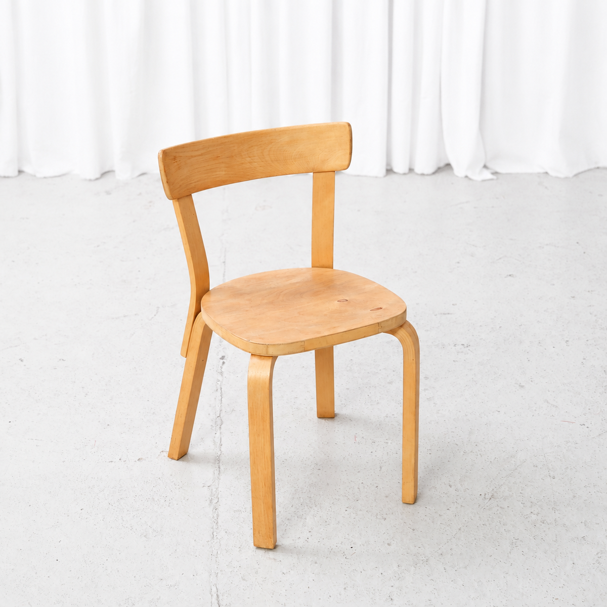 Front angled view of a 1950s Artek Chair 69 in birch