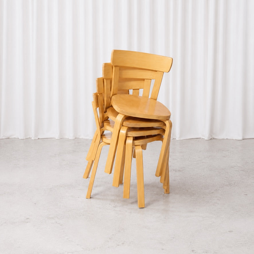 Four Artek Chair 69 chairs in birch stacked together