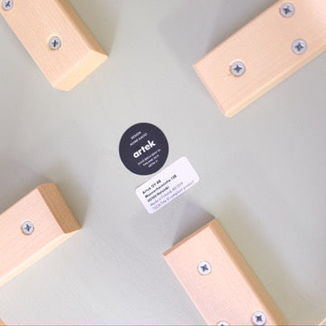 Underside label and leg fixings of an Artek E60 stool dated 2019