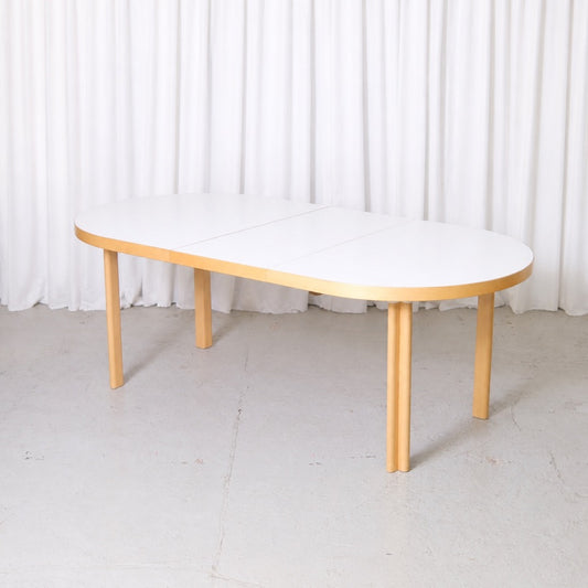 Artek H99 dining table extended with its central leaf