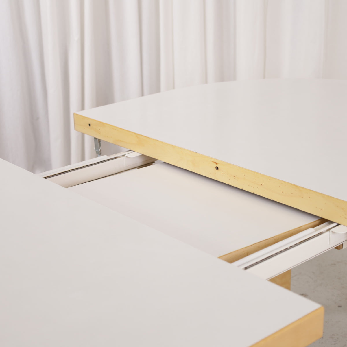 Artek H99 table opened to insert the extension leaf