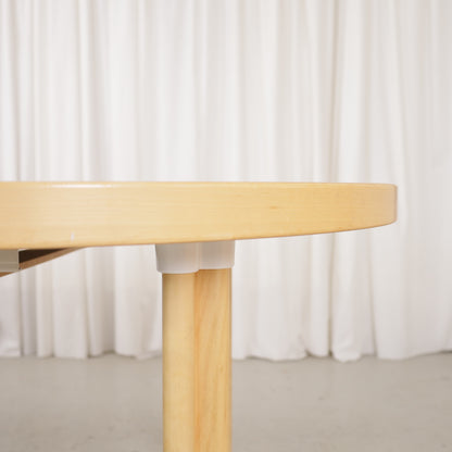 Artek H99 extendable table in white laminate and birch — tabletop edge and sleeve leg detail