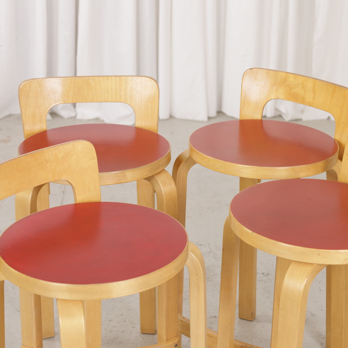 Alvar Aalto K65 high chair for Artek in patinated birch with a red linoleum seat