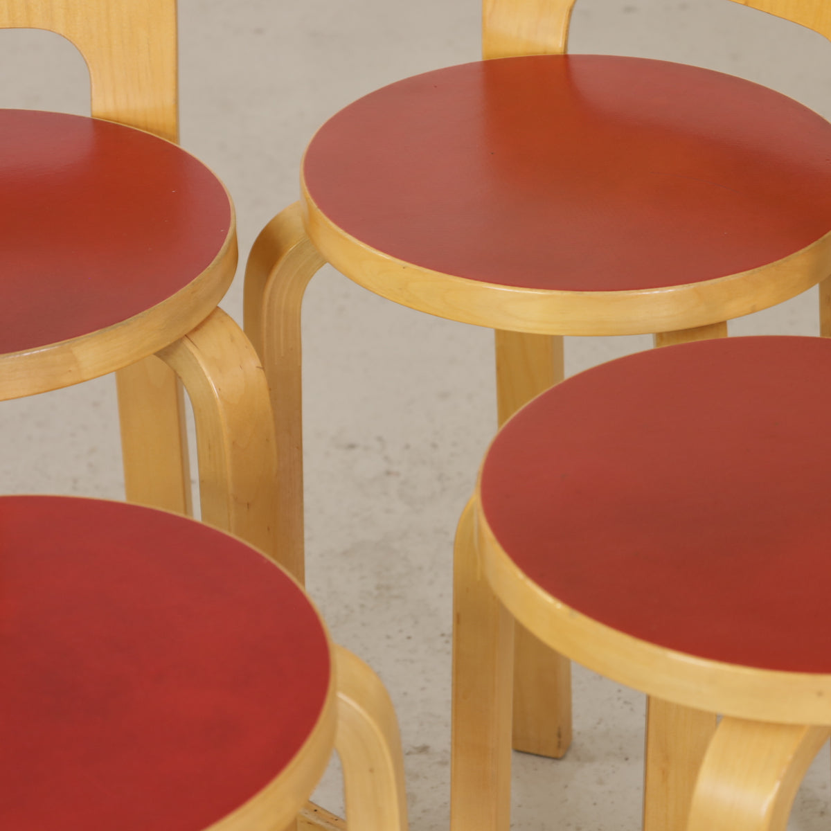 Alvar Aalto K65 high chair for Artek in patinated birch with a red linoleum seat