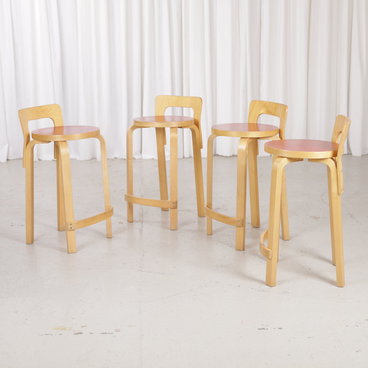 Alvar Aalto K65 high chair for Artek in patinated birch with a red linoleum seat