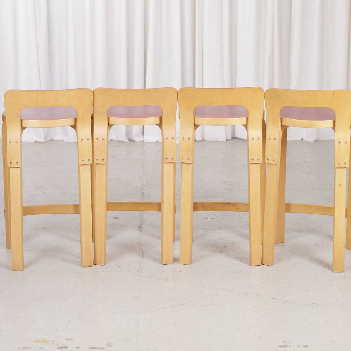 Alvar Aalto K65 high chair for Artek in patinated birch with a red linoleum seat