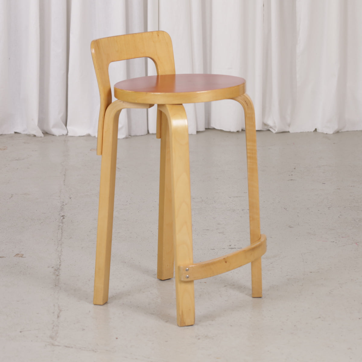 Alvar Aalto K65 high chair for Artek in patinated birch with a red linoleum seat