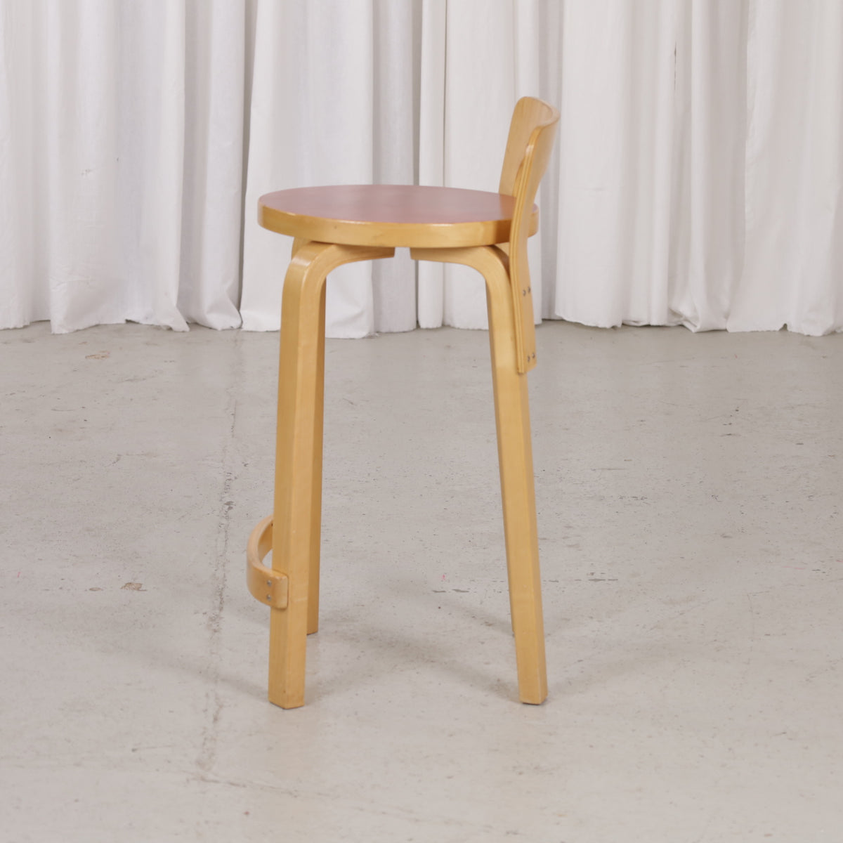 Alvar Aalto K65 high chair for Artek in patinated birch with a red linoleum seat