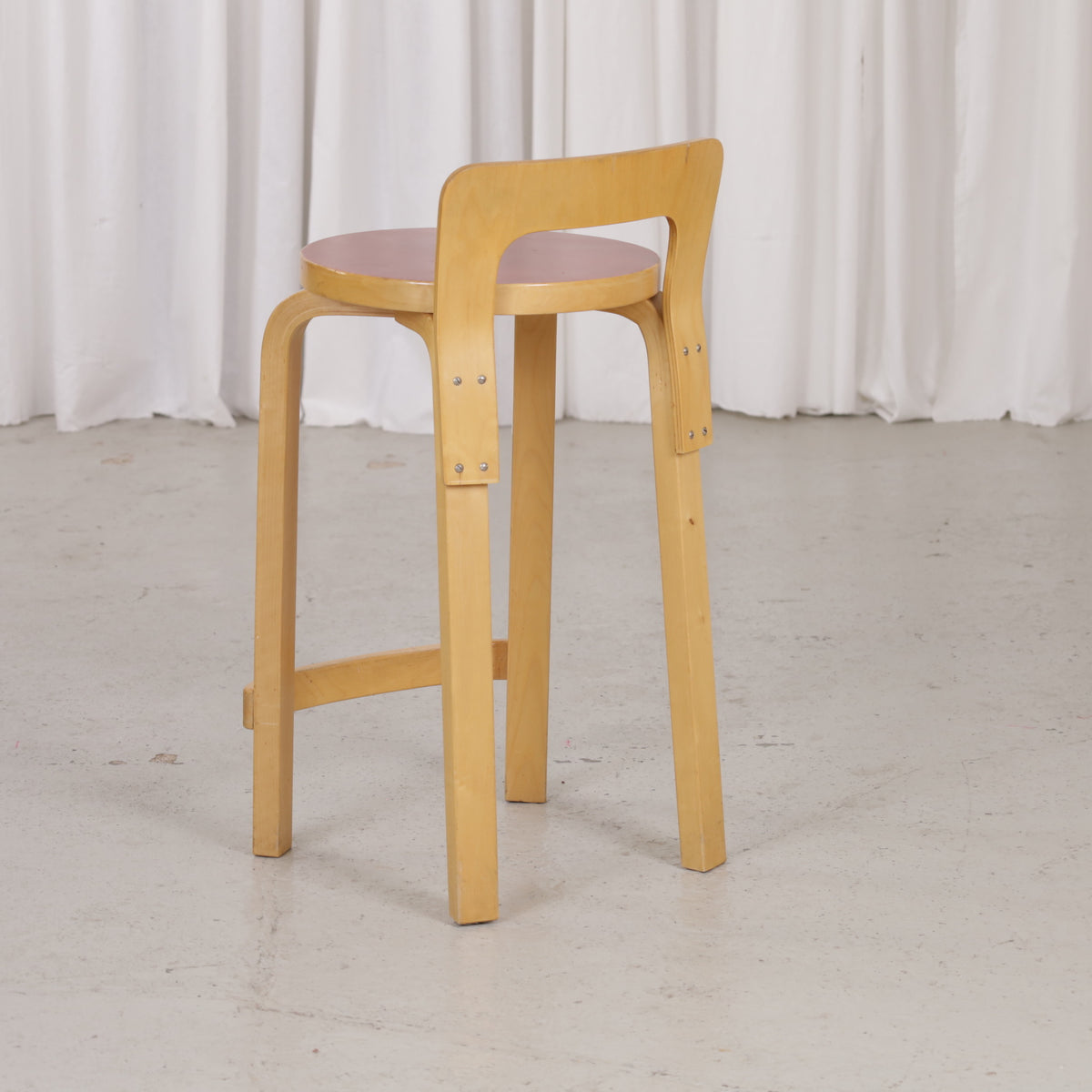 Alvar Aalto K65 high chair for Artek in patinated birch with a red linoleum seat