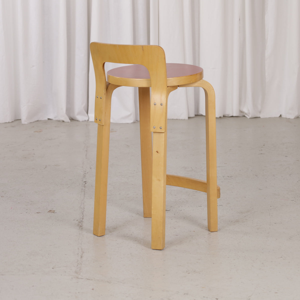 Alvar Aalto K65 high chair for Artek in patinated birch with a red linoleum seat