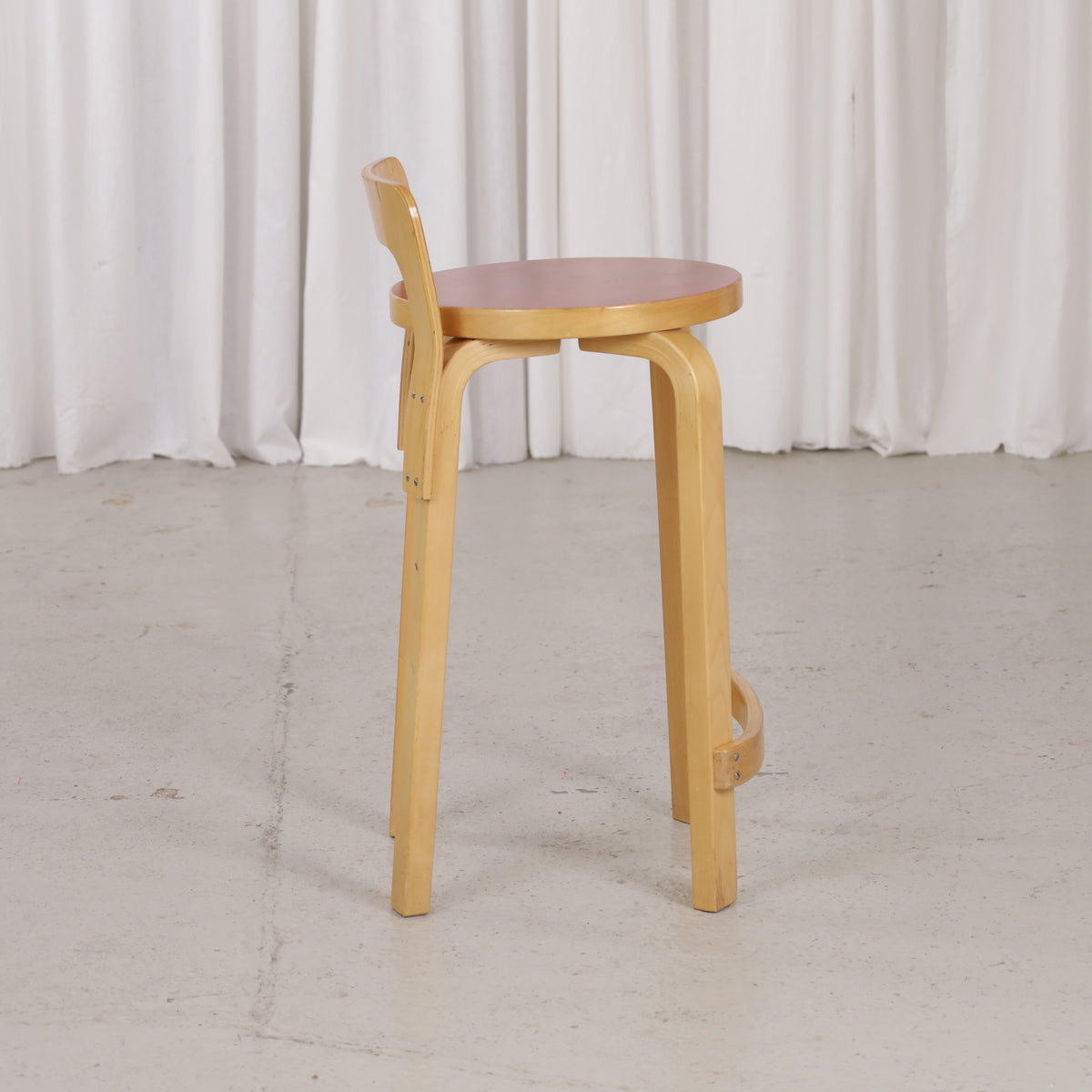 Alvar Aalto K65 high chair for Artek in patinated birch with a red linoleum seat