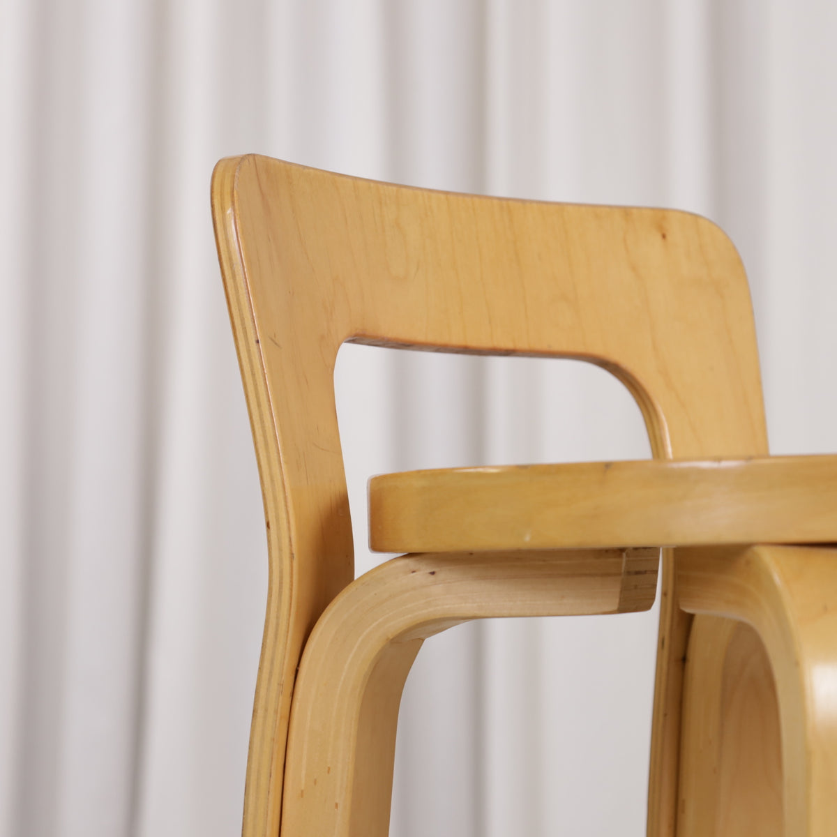 Detail of veneer wear on one Artek K65 backrest