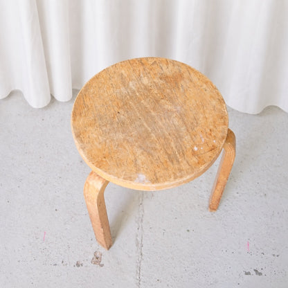 Top view of vintage Artek Stool 60 showing worn birch seat