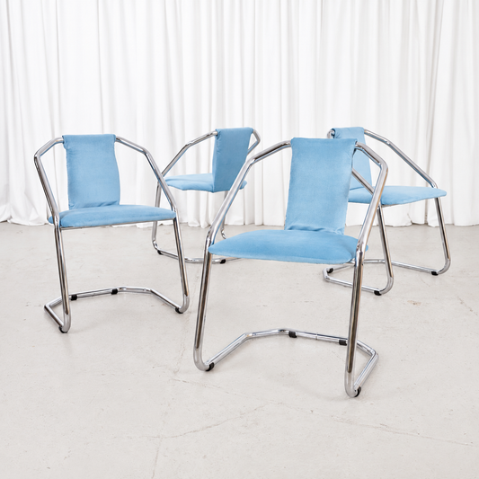 Four Italian-style chrome dining chairs with blue upholstery, sold individually