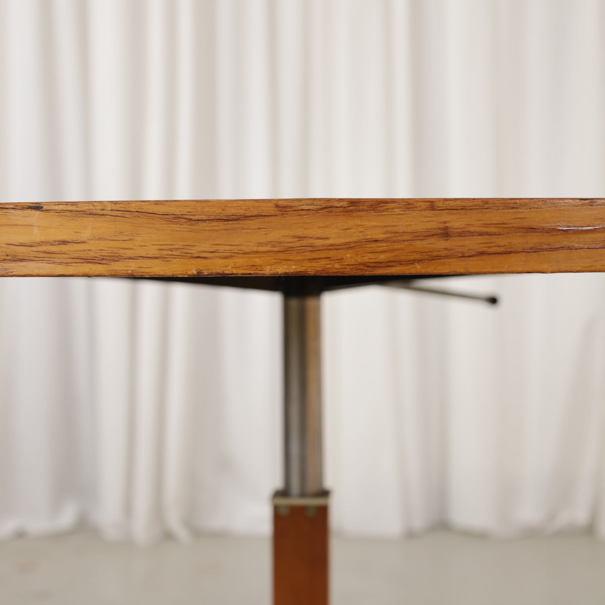 Vintage height-adjustable table with teak top and chrome base — surface, base or mechanism detail