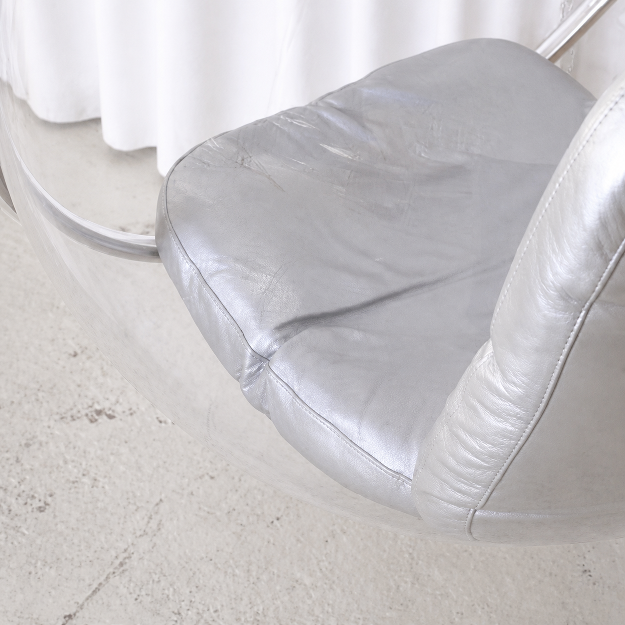 Silver leather seat cushion detail on Eero Aarnio Bubble Chair