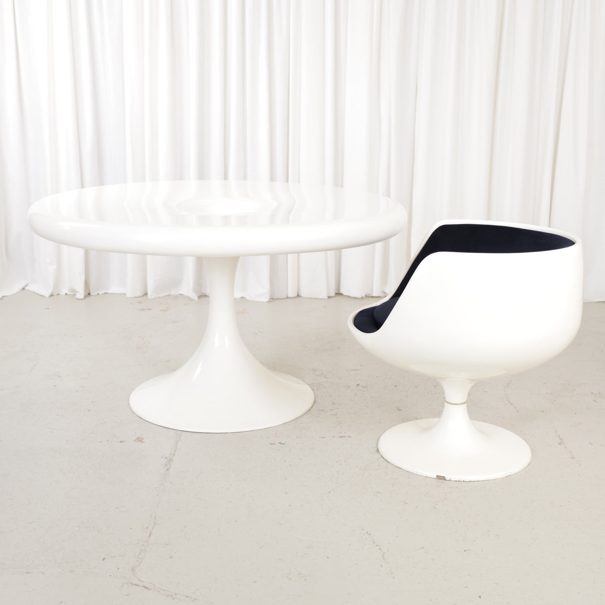 White Eero Aarnio Kanttarelli dining table for Asko, styled with a chair that is not included